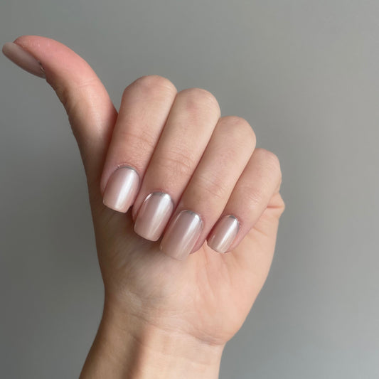 short square press on nagels. Een nude kleur met subtiele shimmer en onderaan een zilveren lijn. 